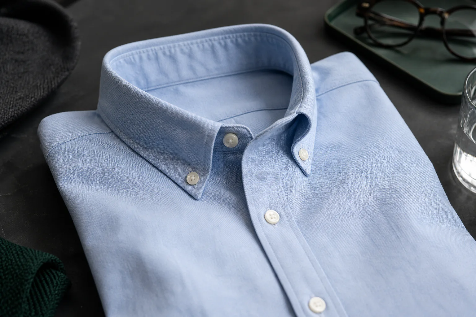 Folded light-blue Oxford shirt with a soft button-down collar roll